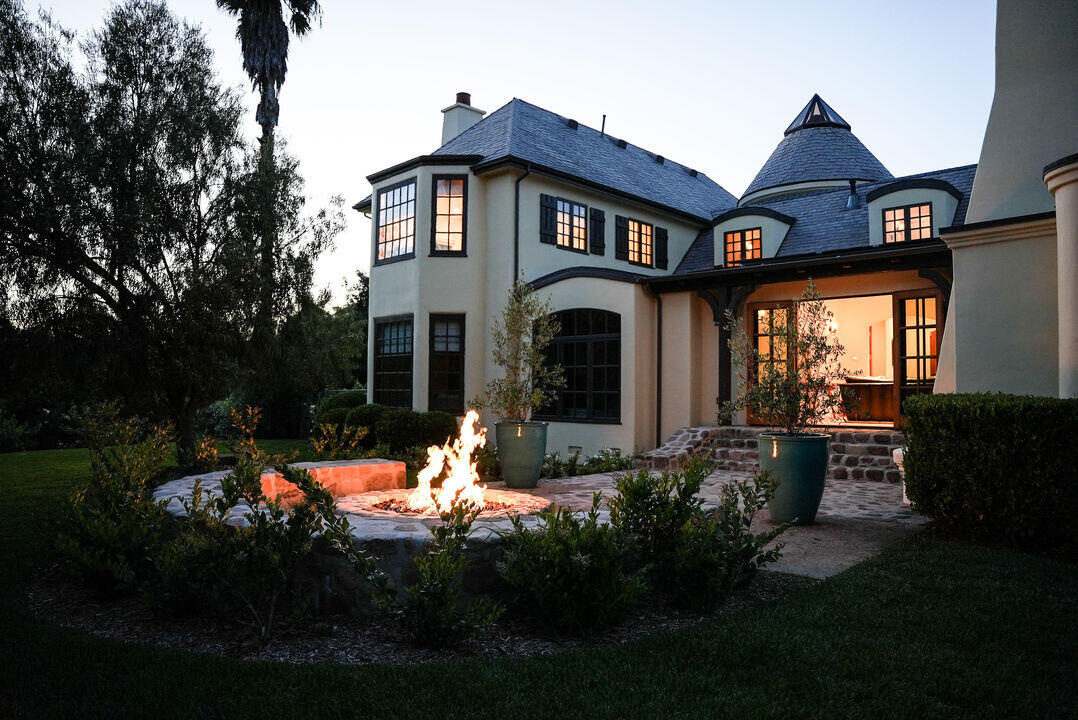 Outdoor fireplace and property at night